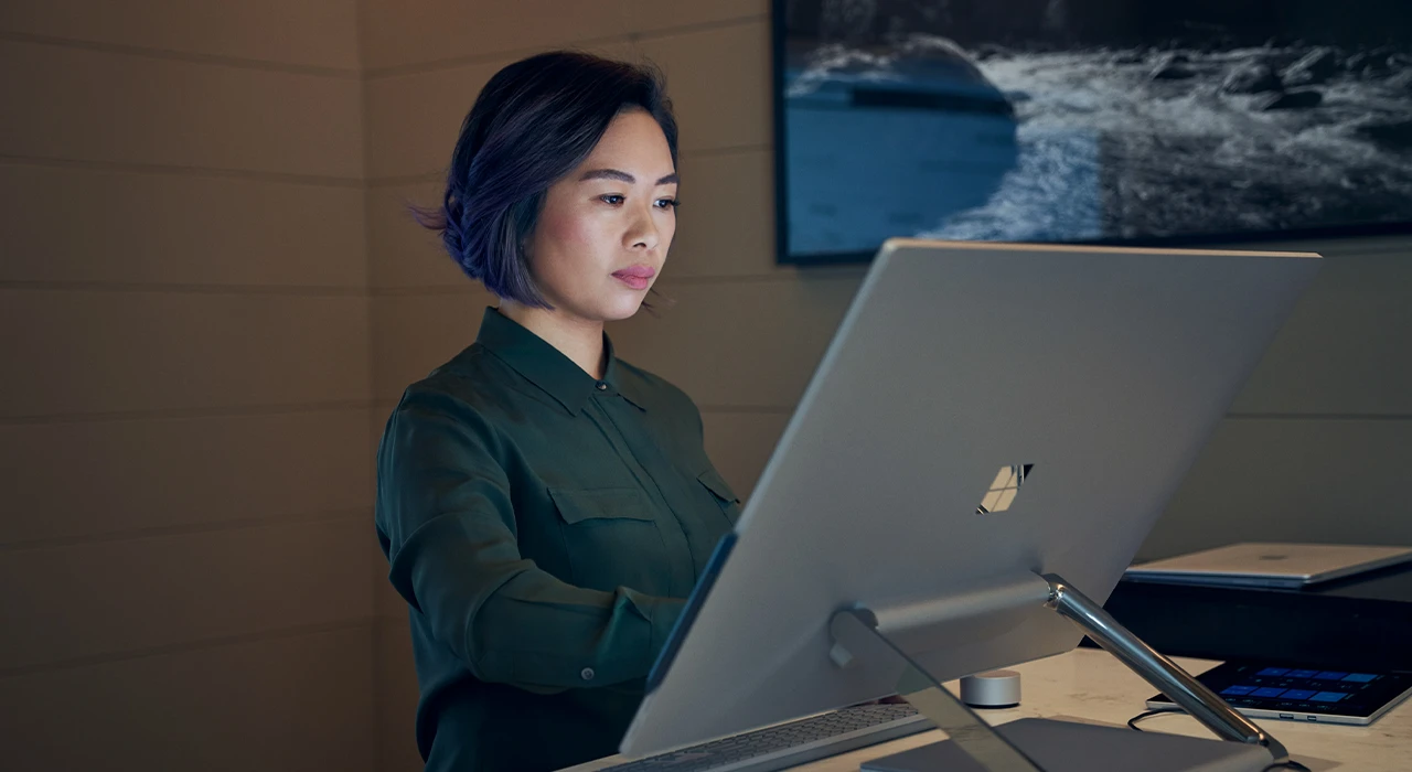Person working at a desktop computer in a modern office setting