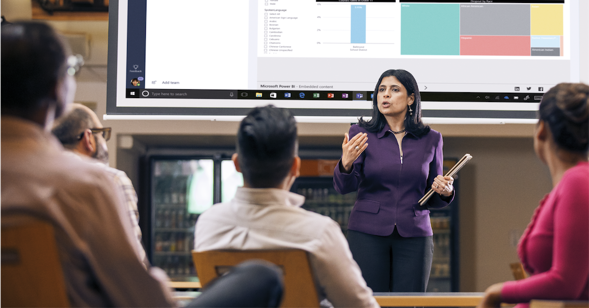 A business person giving an interactive presentation to a group of attendees