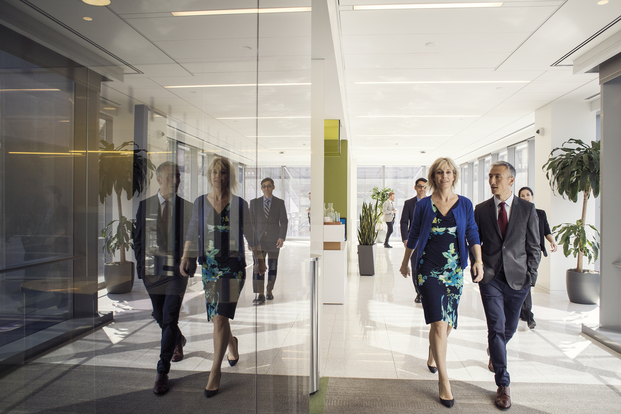 A group of people walking on in the office