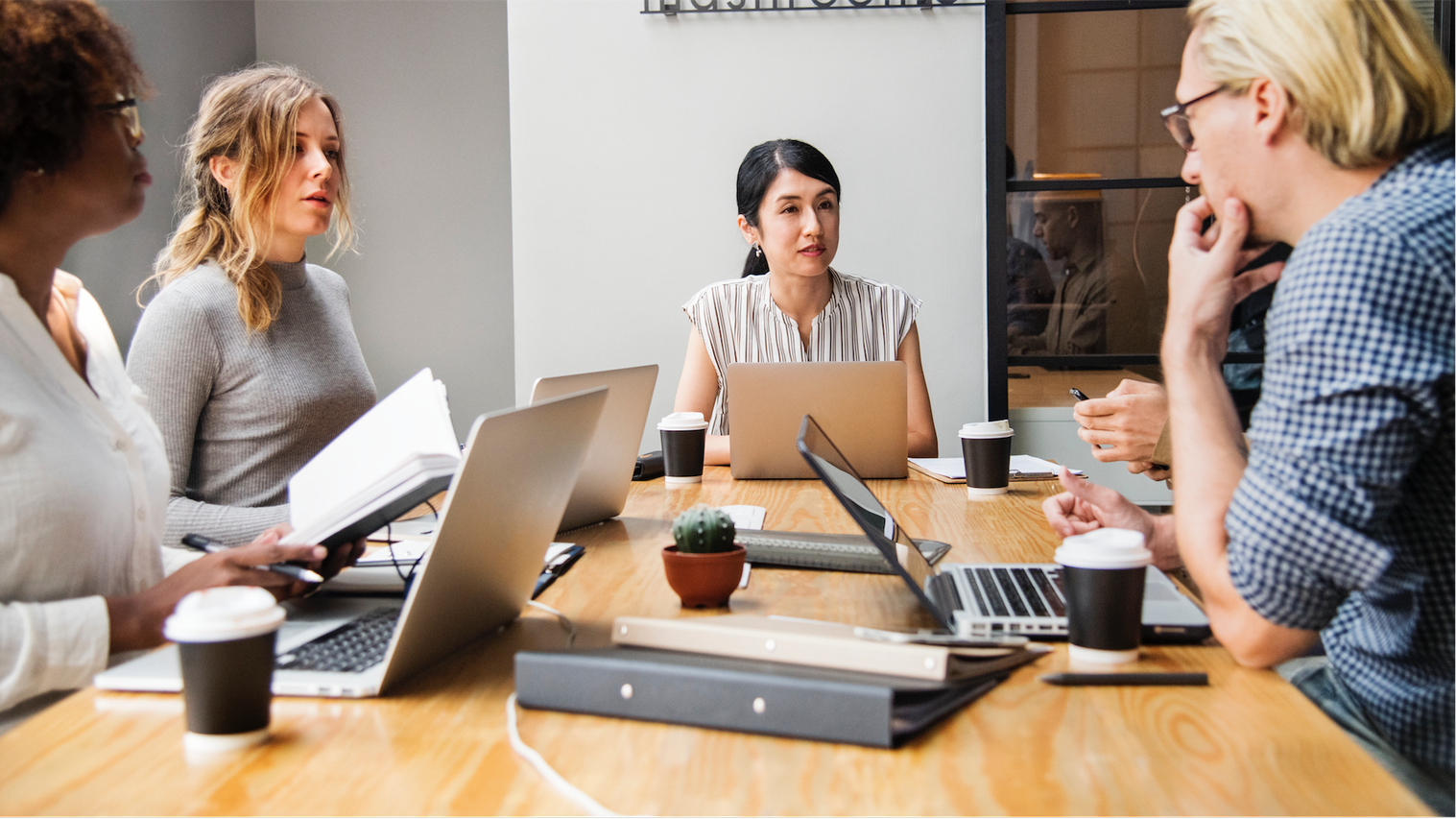 A group of colleagues in discussion in a conference room