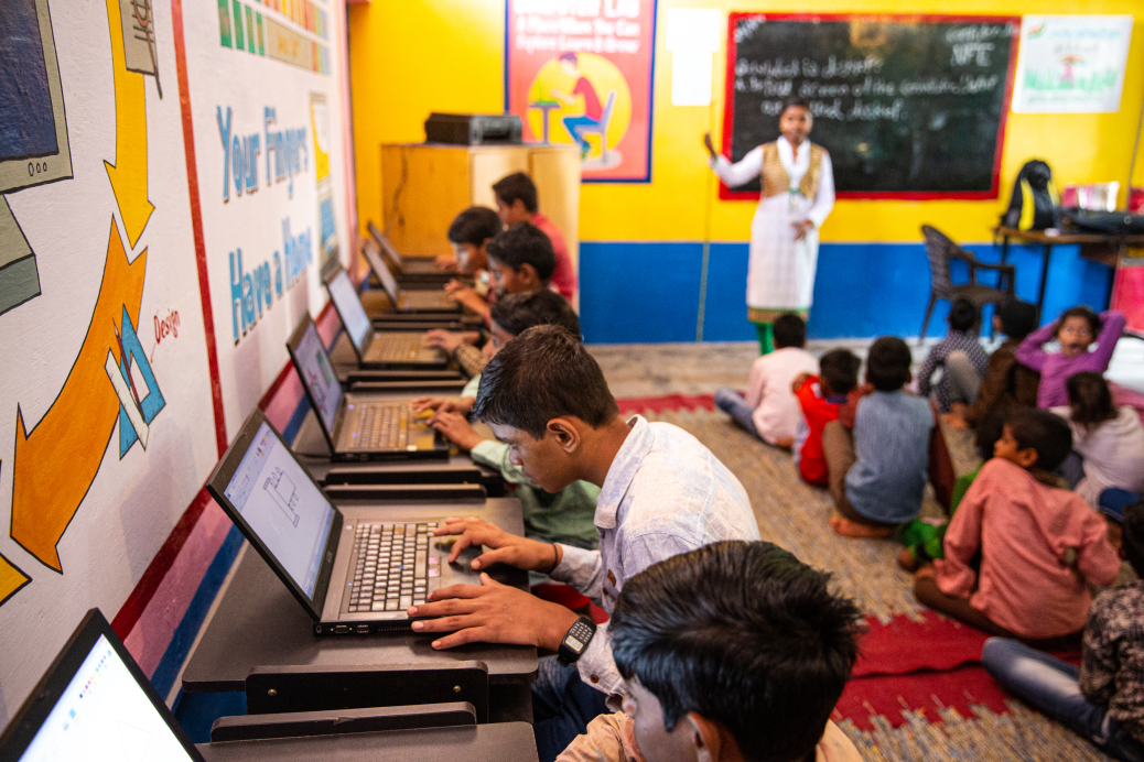 Students learn basic computer skills on laptop computers in classroom of a primary school near Delhi