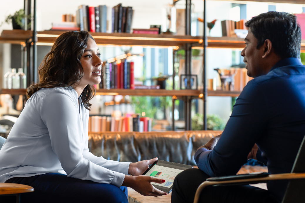 Two people meeting in the hotel lobby ahead of client presentation