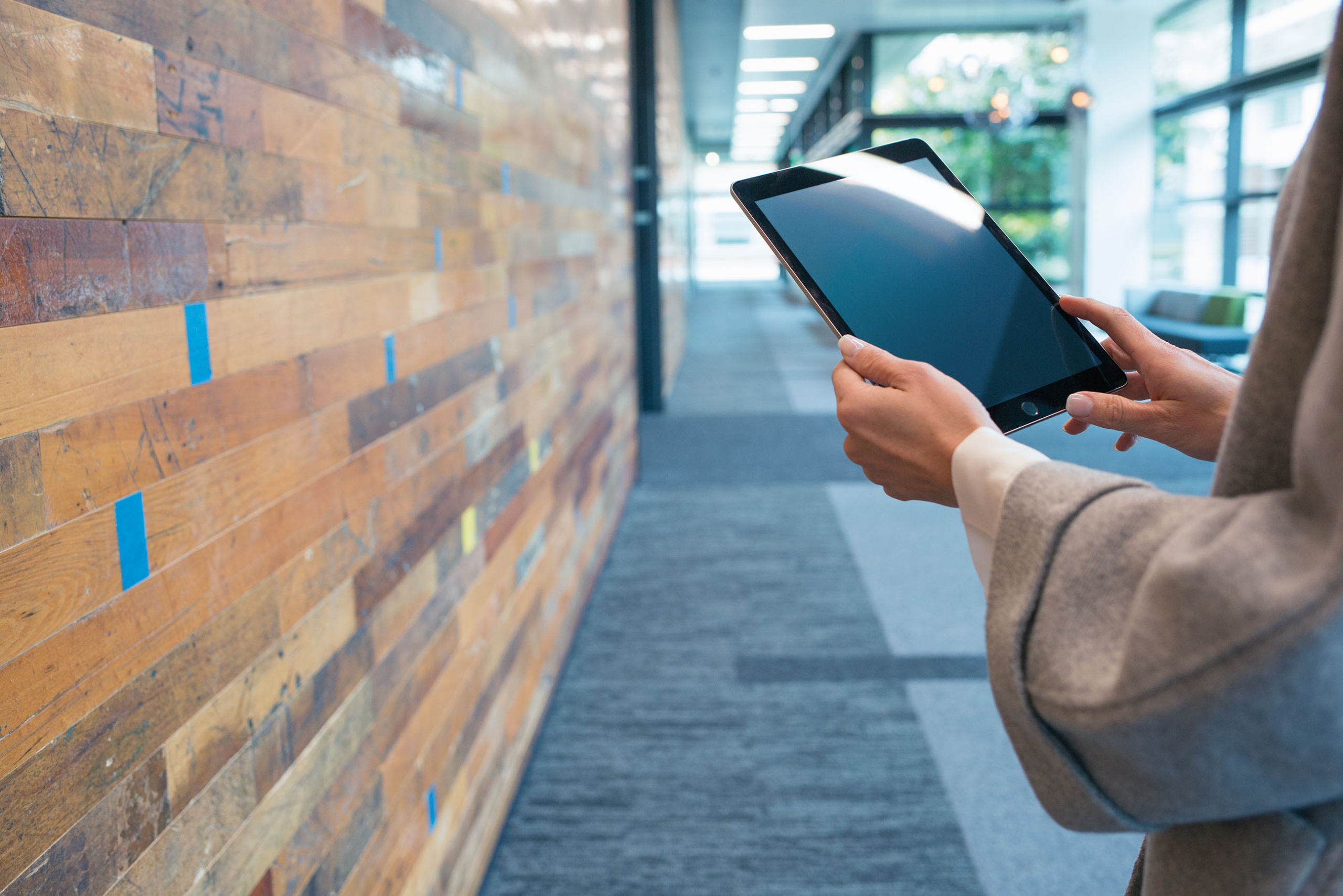 A persons arms holding a tablet