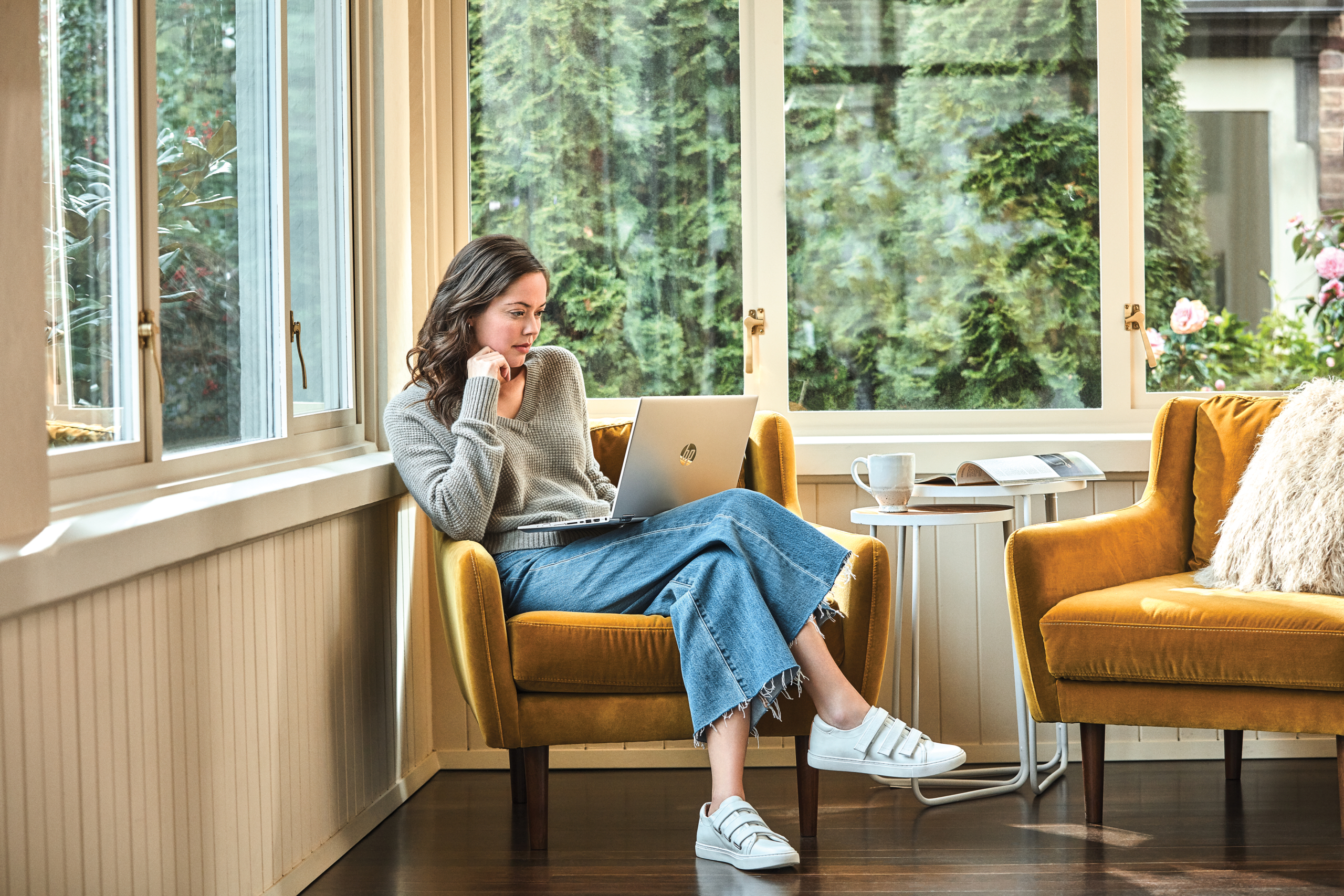 Woman interacting with a HP Pavilion laptop