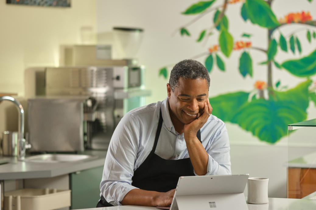 Restaurant owner keeping working at desk. Microsoft 365 and Surface. Small business owner. Male, food, coffee, restaurant, Covid, pandemic, inventory