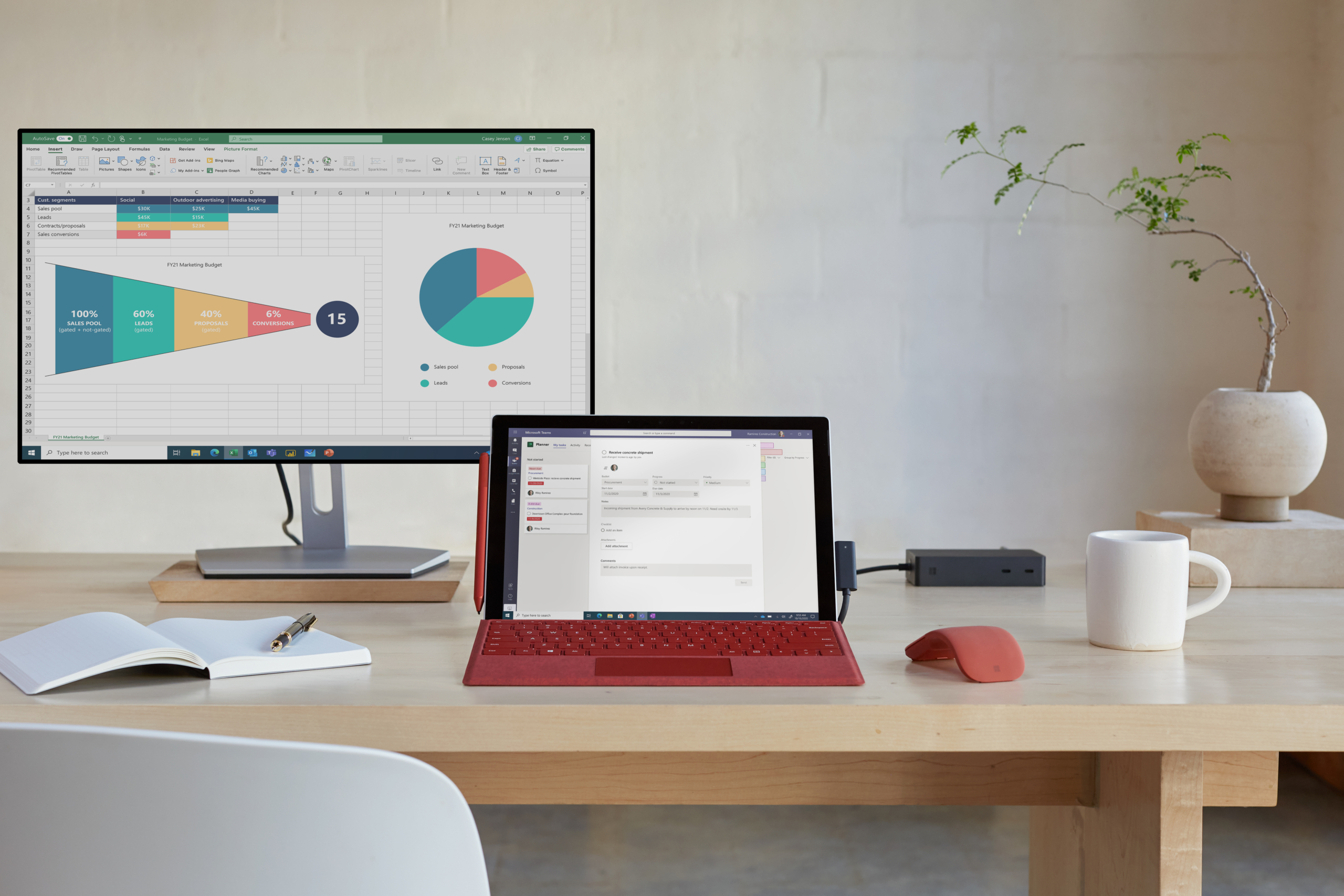 Front view of a Surface Pro 7+ with a poppy red keyboard and poppy red Surface Arc Mouse. Surface Pro 7+ screen is displaying Microsoft Teams and the monitor is displaying Microsoft Excel