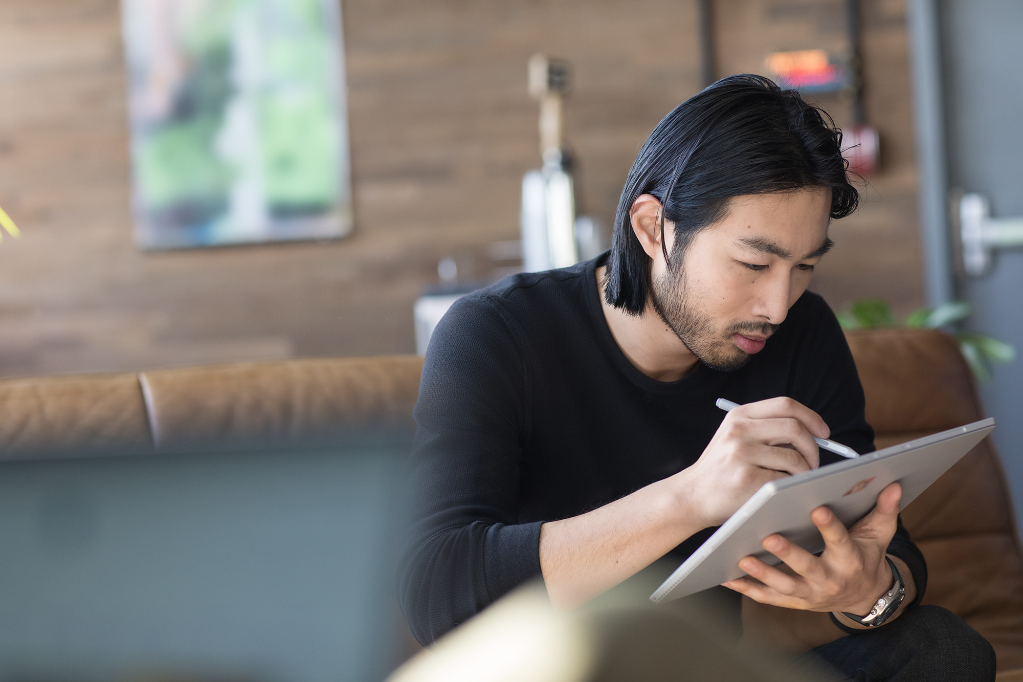 Small business male with Surface in modern workplace