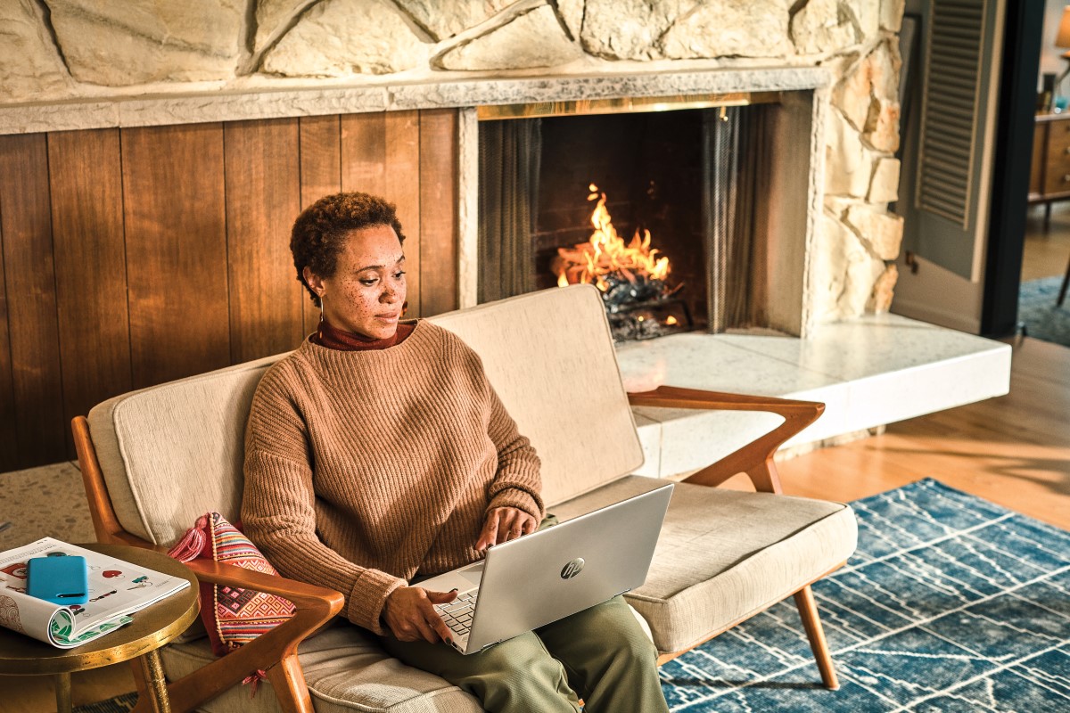 Woman interacting with a HP Pavillion laptop