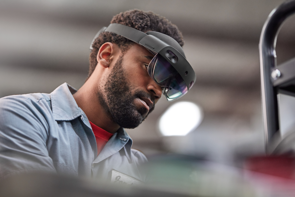 Man using Dynamics 365 Guides to assemble a generator. Lifestyle photography. Contextual imagery
