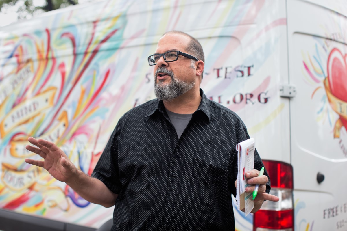 Man in front of a non-profit van