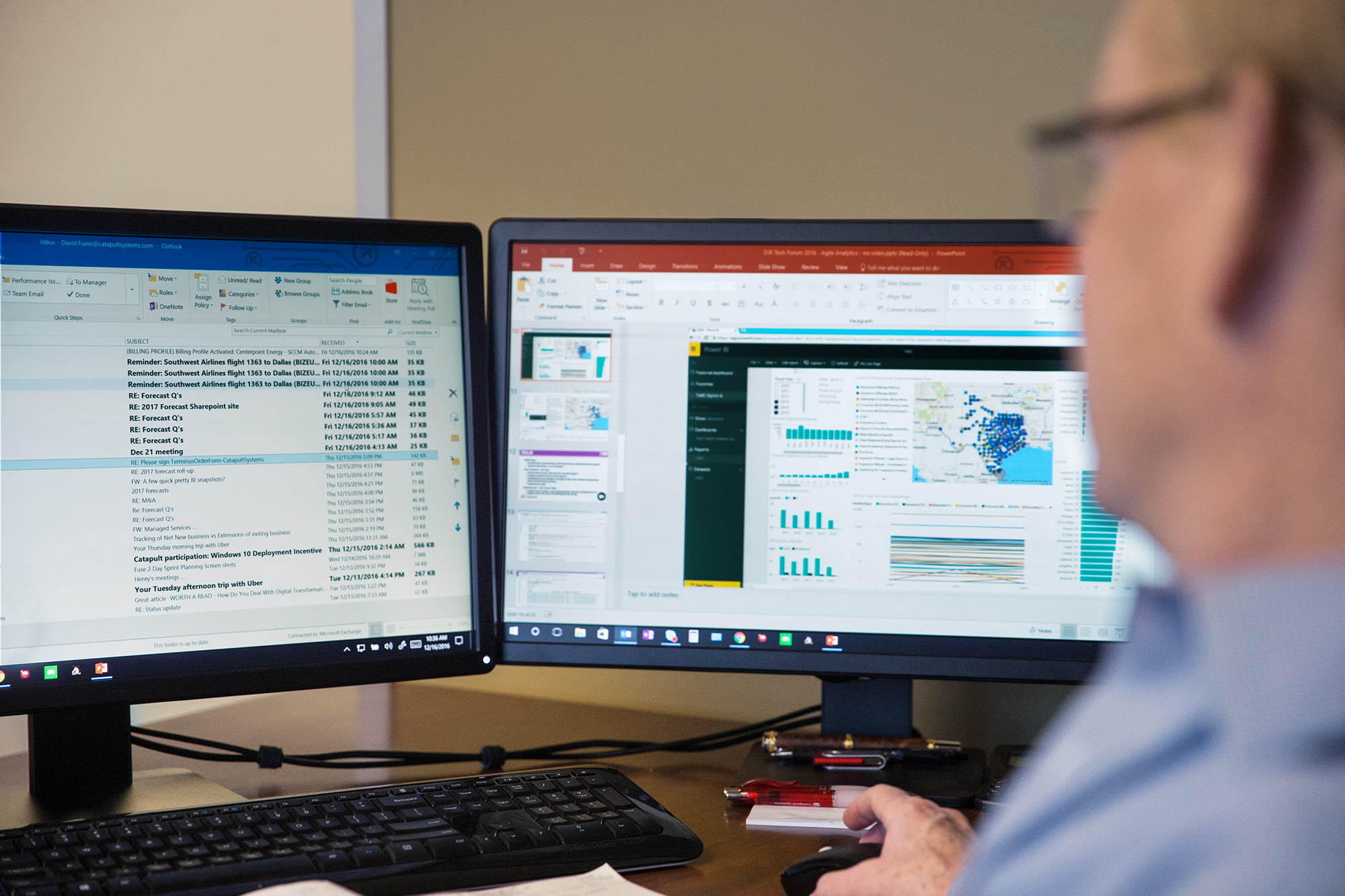 Working on two screens, reviewing data