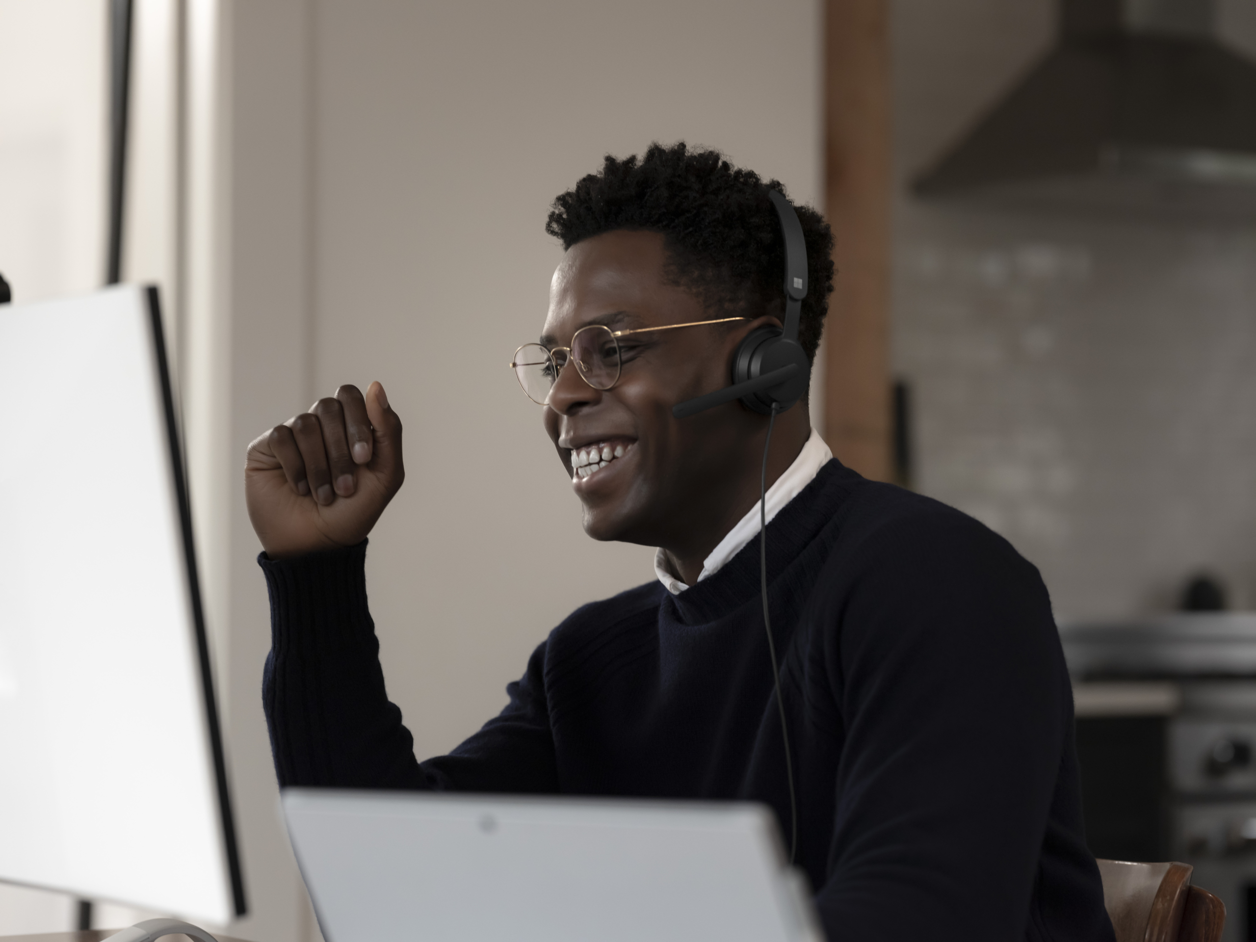 Adult male inside using Microsoft Modern USB Headset