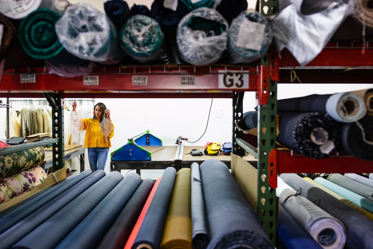 Woman working in storeroom within the factory; reviewing contents