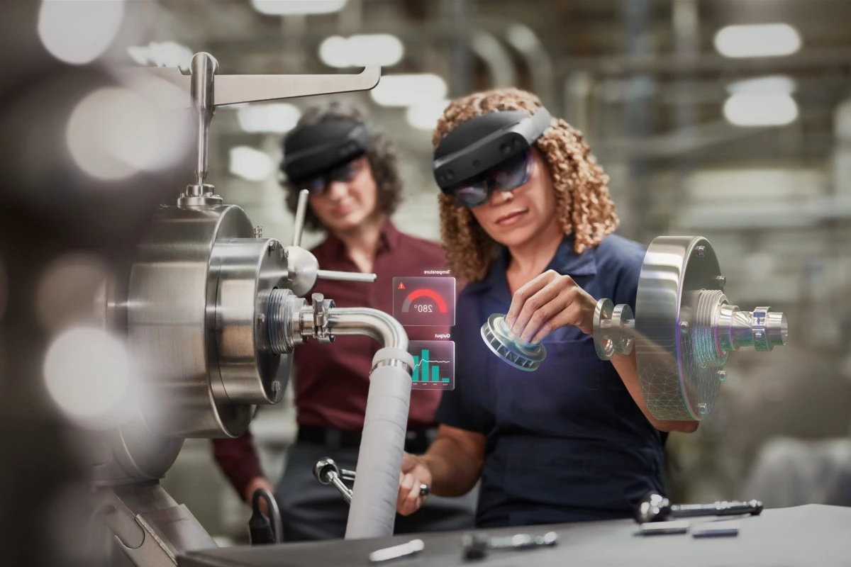 Two women in manufacturing plant using Microsoft Hololens 2 for assembly