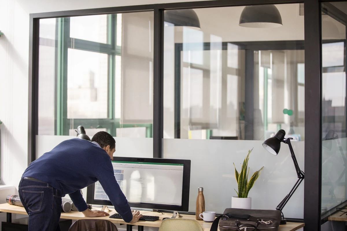 Small business male with All-in-one in modern workplace