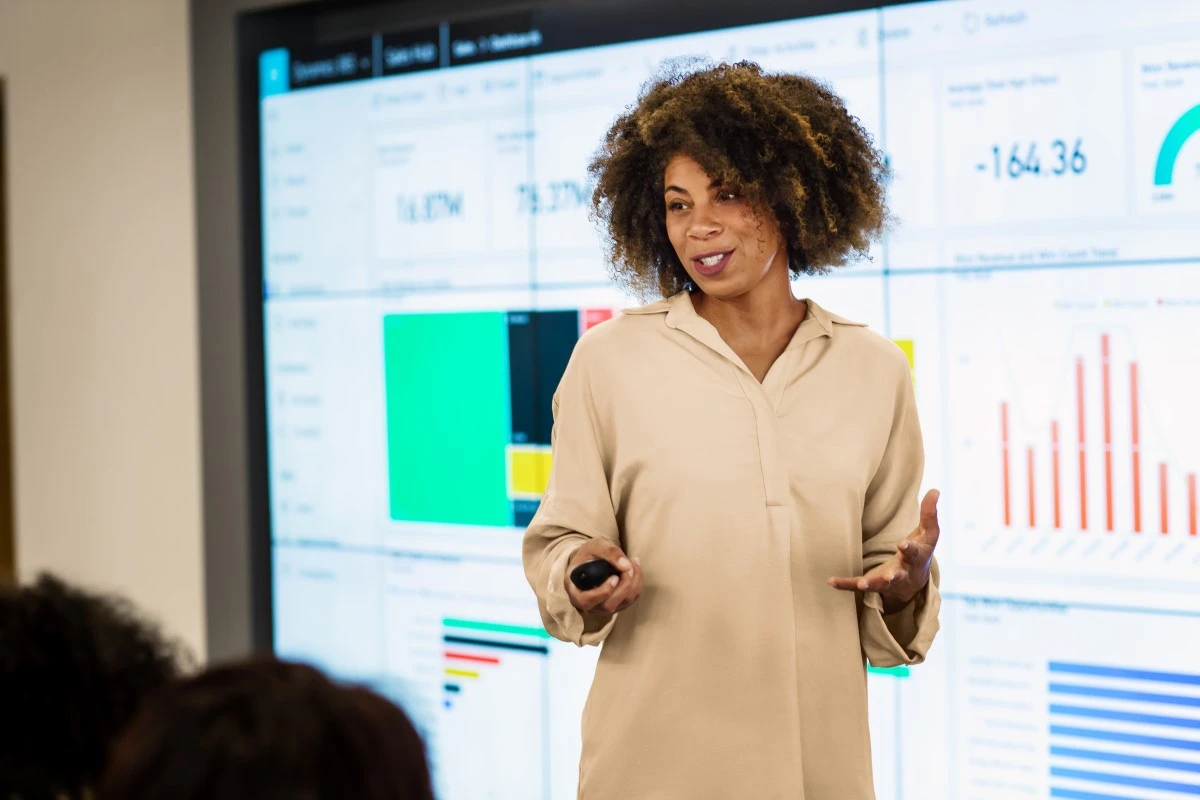 CFO presenting sales results to large group meeting