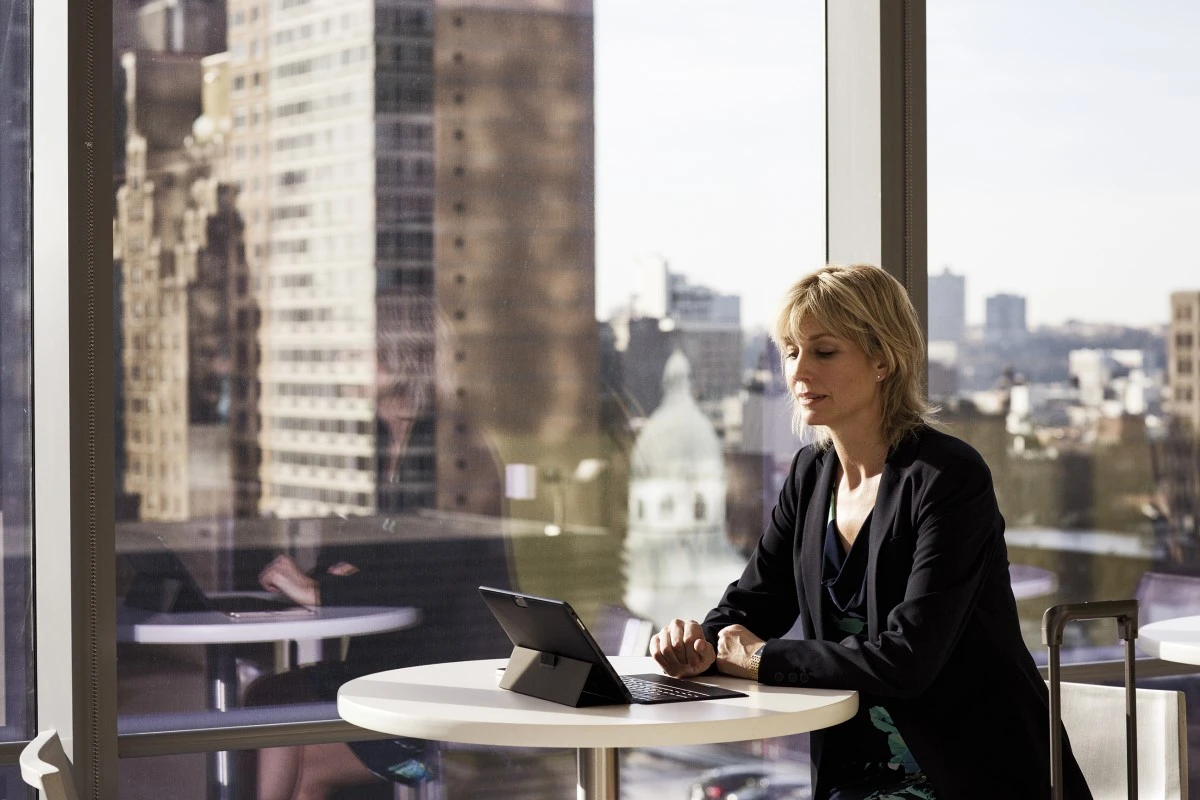 Business woman at table with Surface