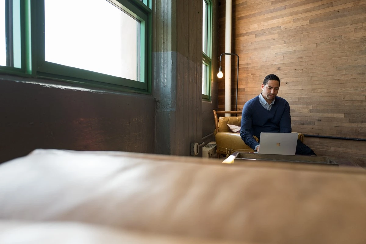 Small business male achieving with a Surface in modern workplace