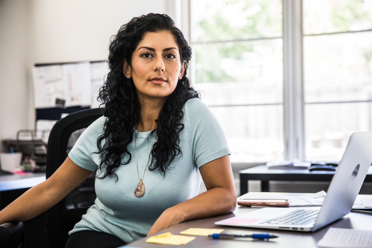 A woman sitting at a desk in an office