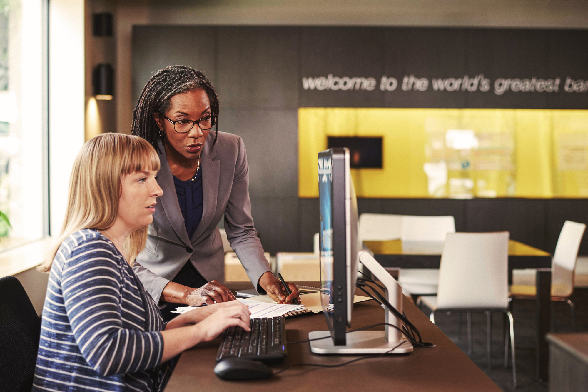 Photo of two female professionals working at a computer