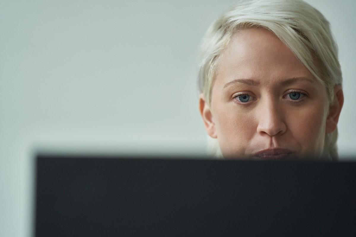 Close-up of a woman focused on her computer screen