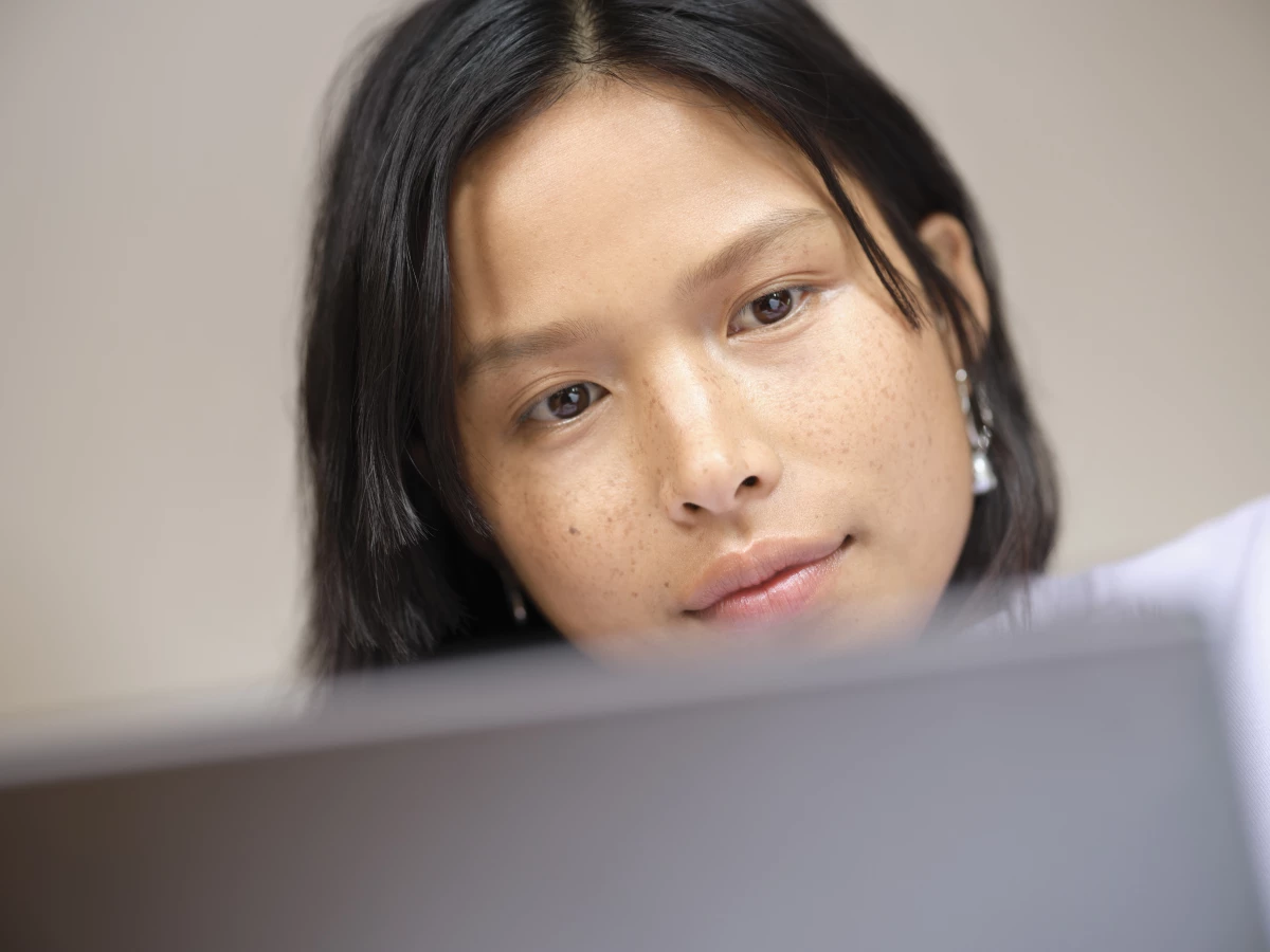 A close-up of a woman looking at a computer