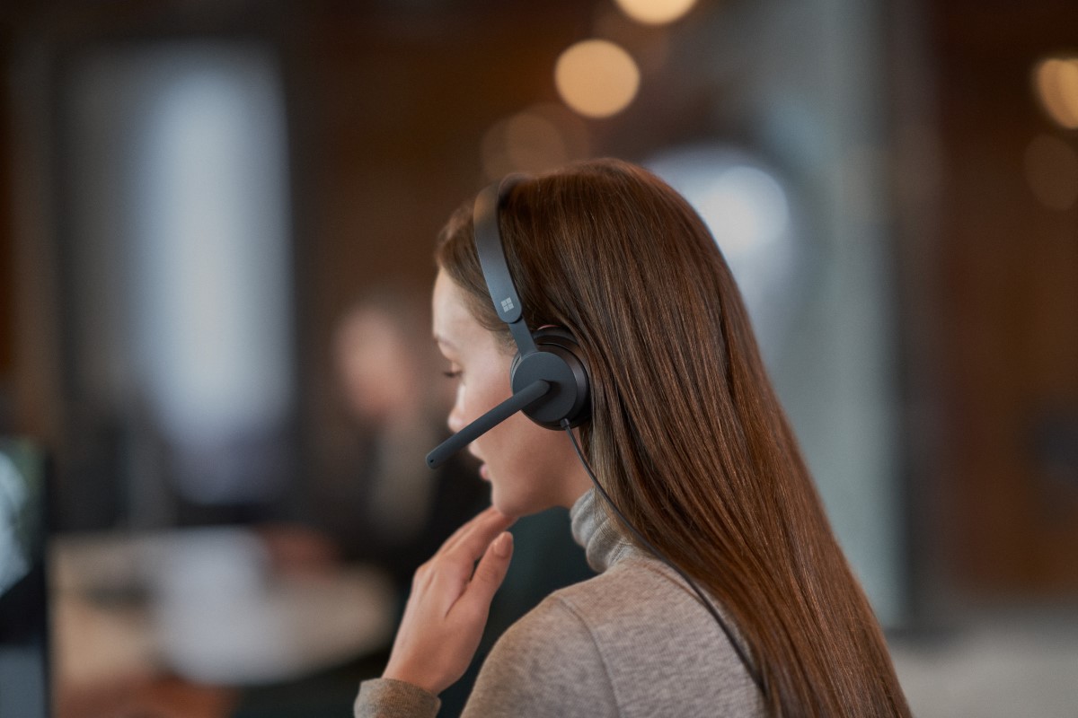 Close-up side view of a woman wearing a headset
