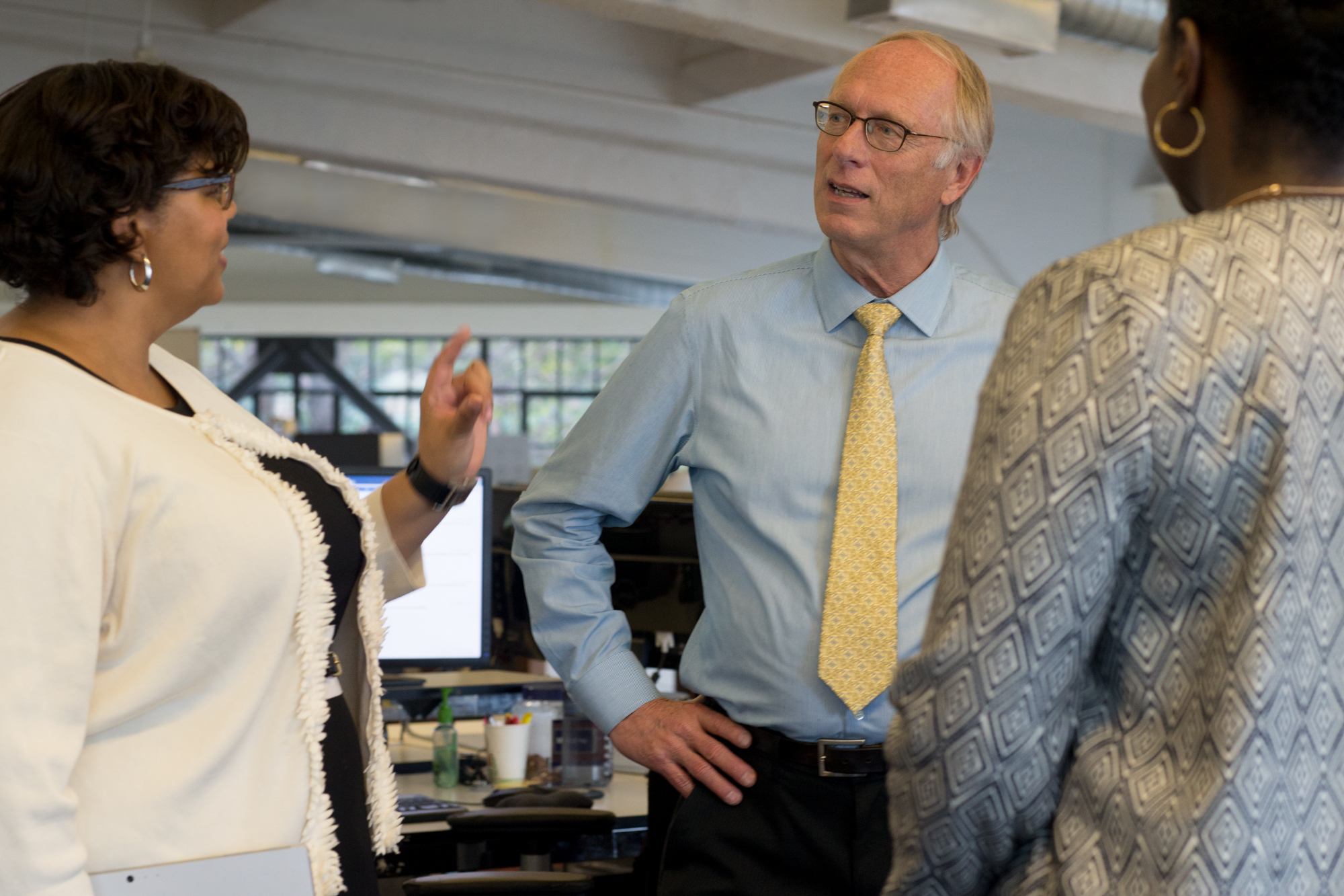 Photo of three accounting executives discussing non-deductible VAT in an office