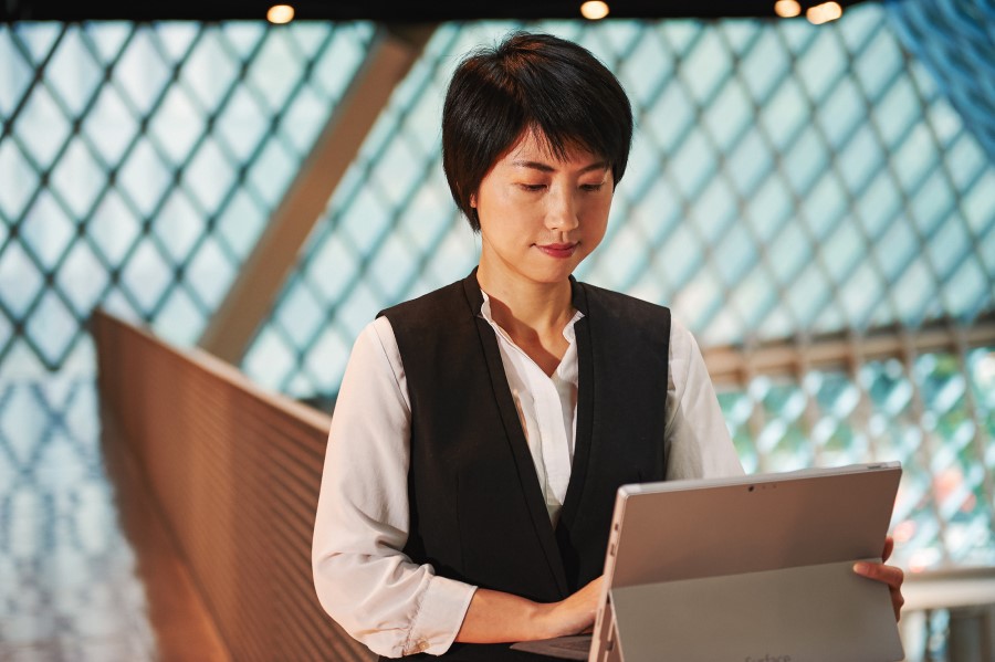 Woman using a Surface Pro inside a library