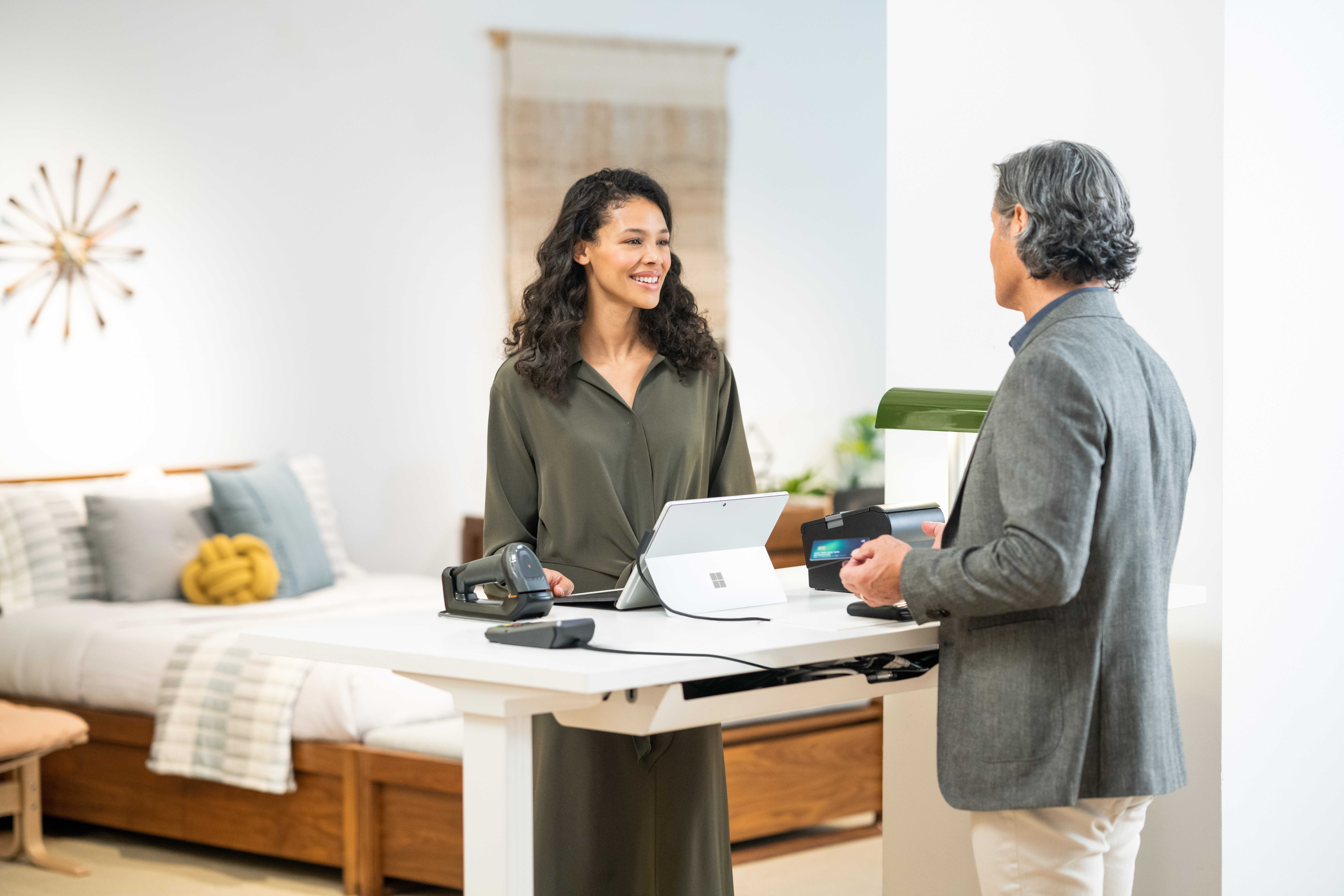 A female and male employee discuss Dynamics 365 implementation projects in an office