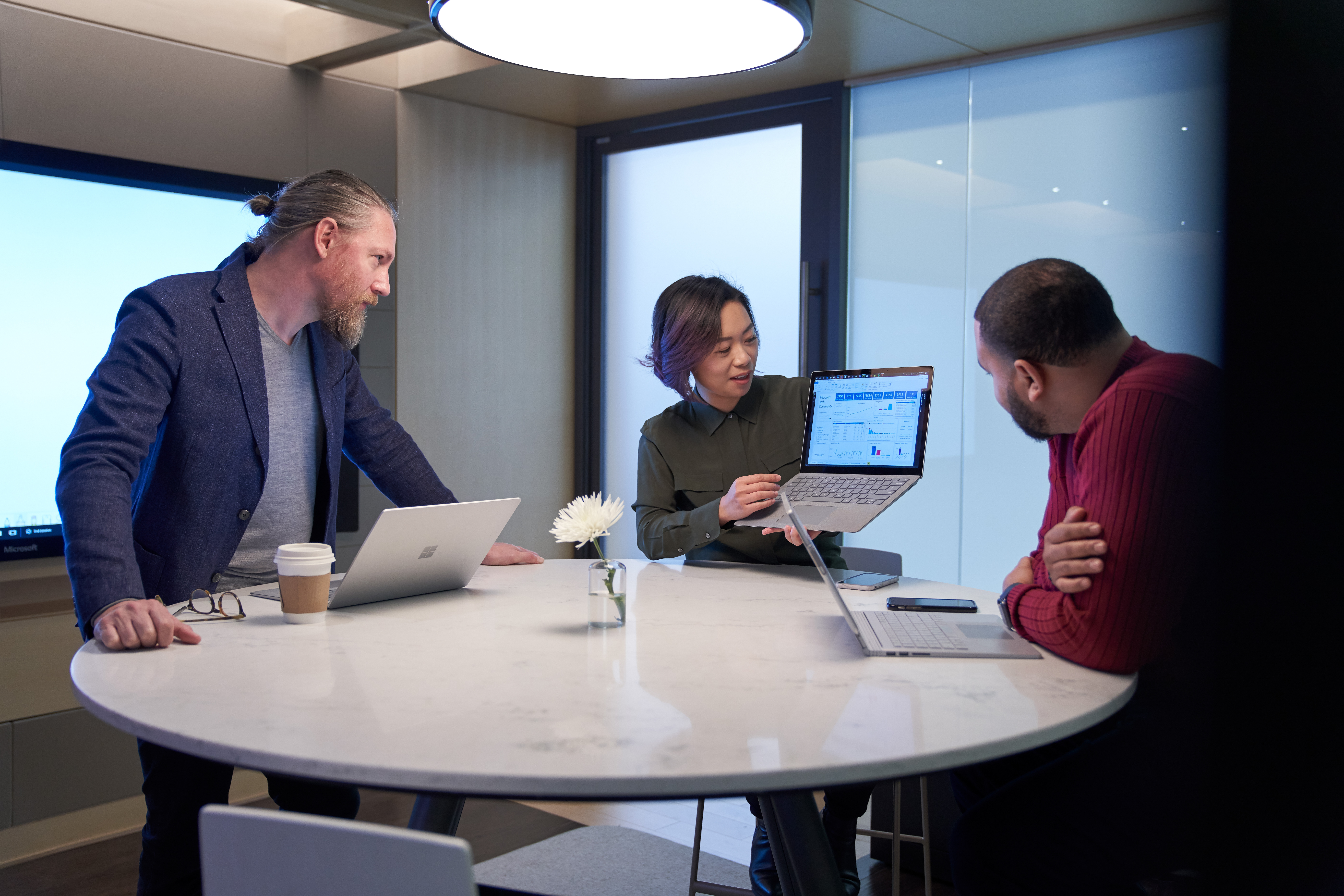 Photo of three colleagues discussing a data maintenance strategy for their organization