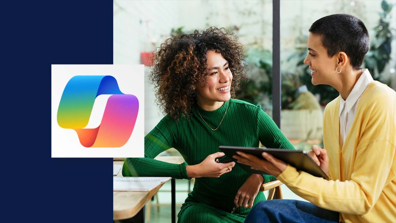 Two people look at each other smiling as one is holding a table. The copilot logo is overlaid on the left side of the image