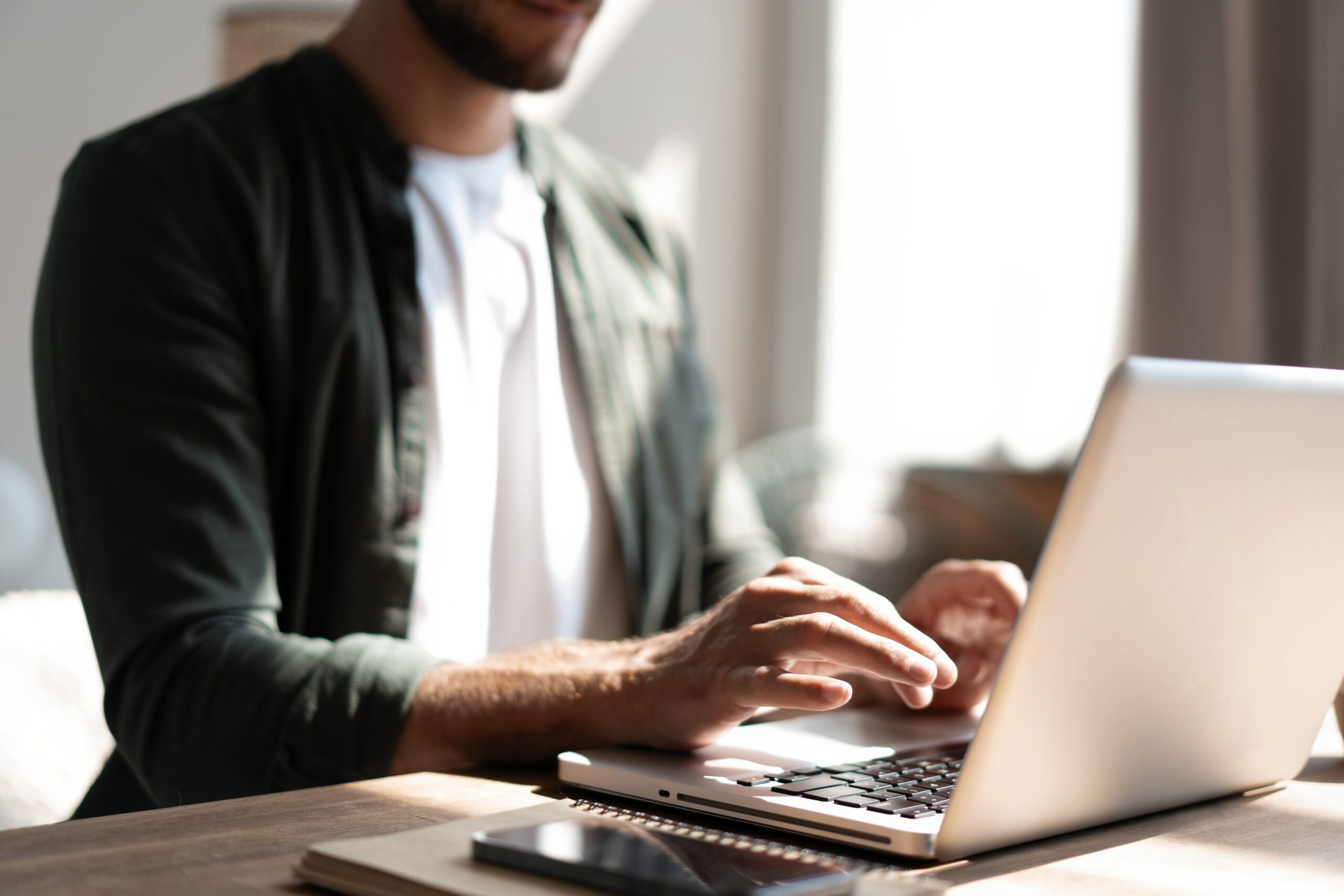 Male remote working from home and having work confrence video call. Freelancer working on laptop at home office