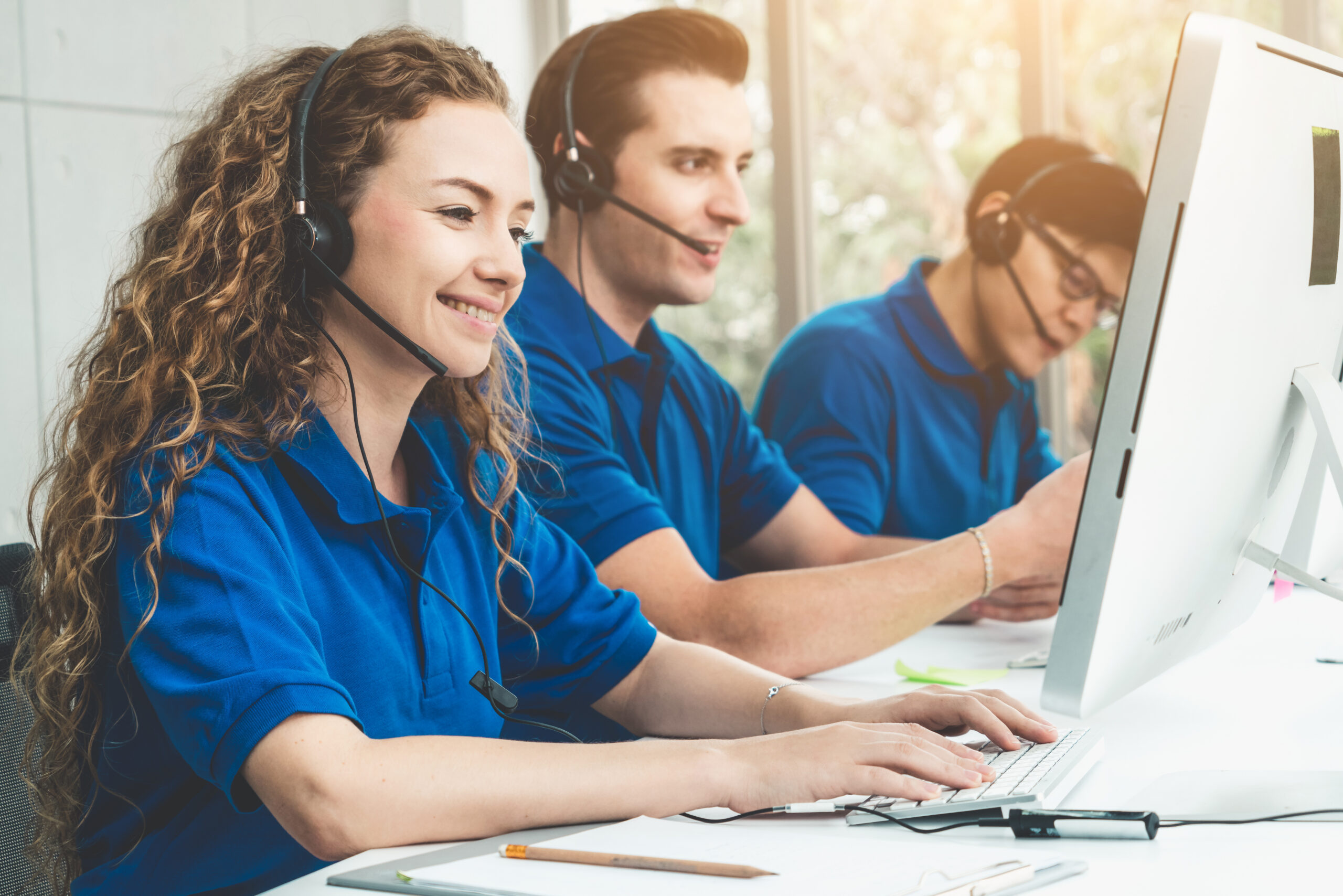 Business people wearing headset working in office to support remote customer or colleague. Call center, telemarketing, customer support agent provide service on telephone video conference call