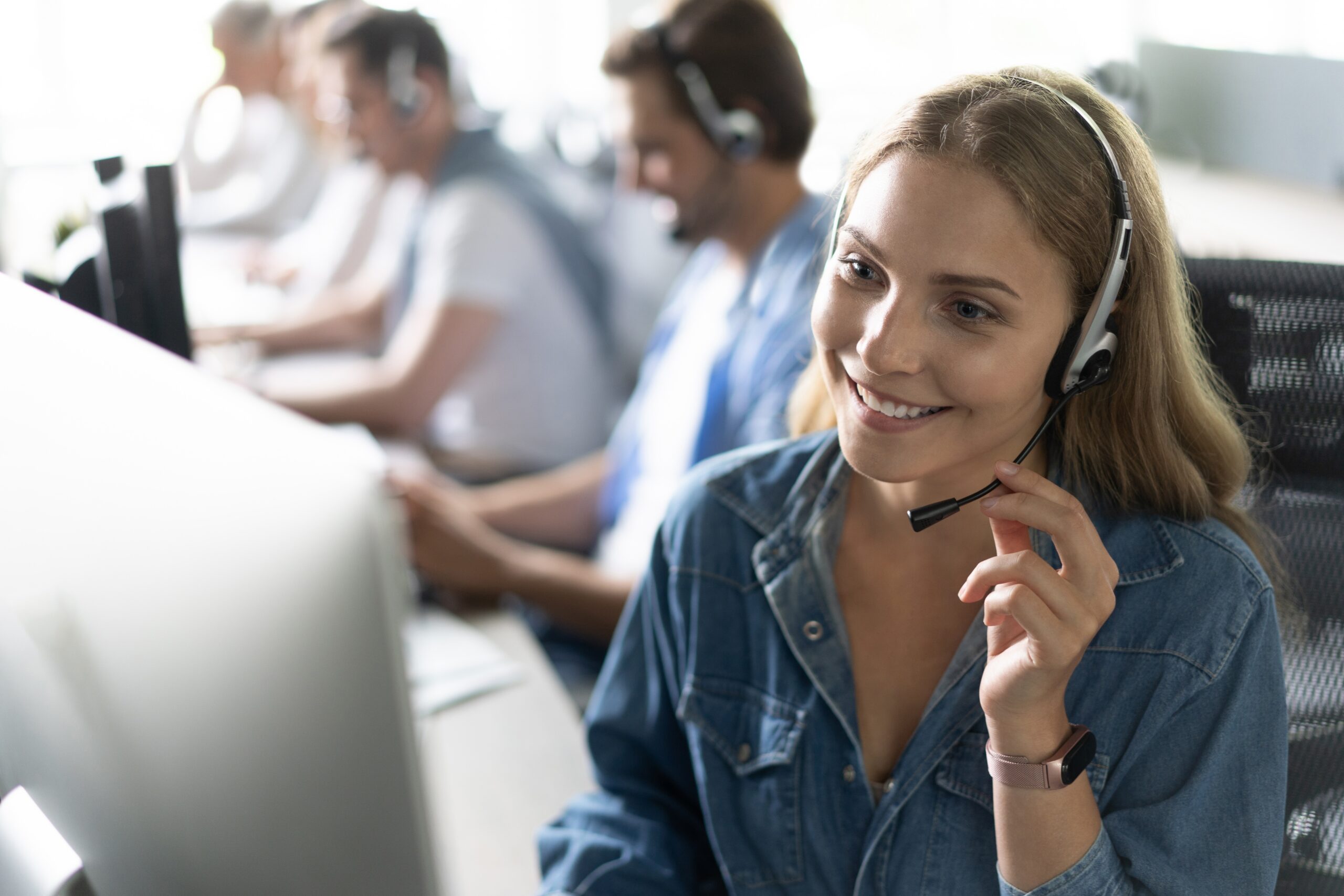 call center workers in headphones are working at modern office