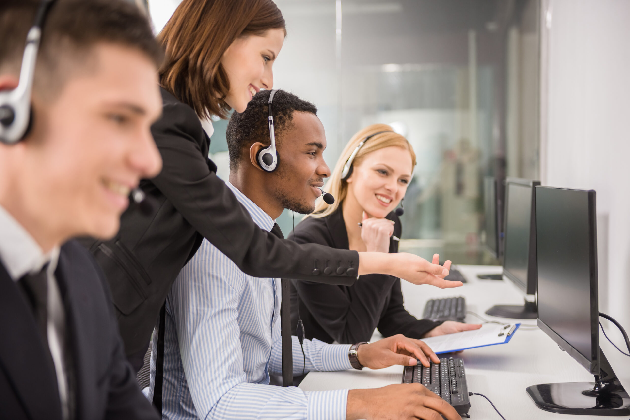 Side view of female manager assisting her staffs in a call center