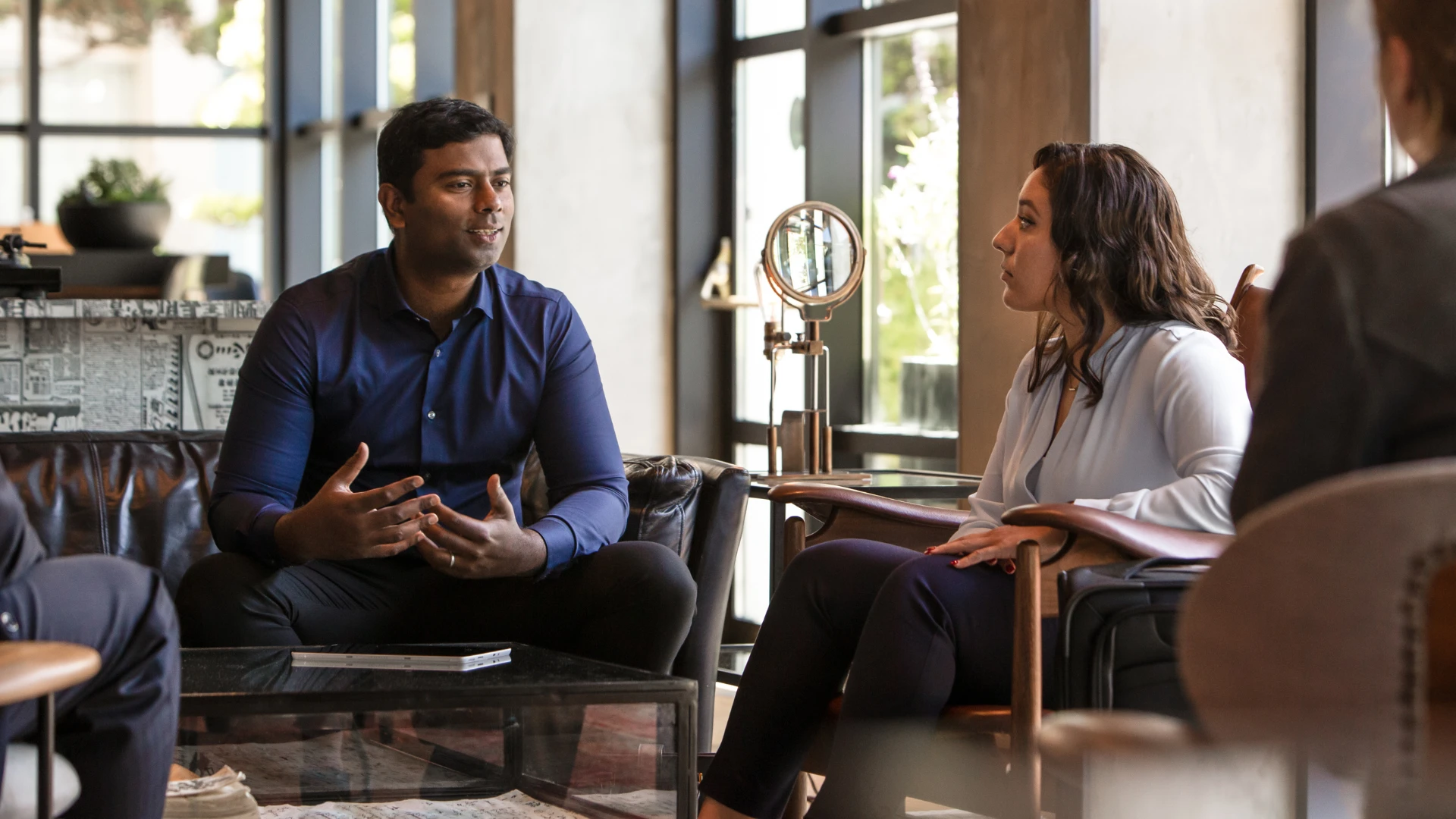 Business professionals collaborating in a customer meeting to streamline sales workflows using Dynamics 365