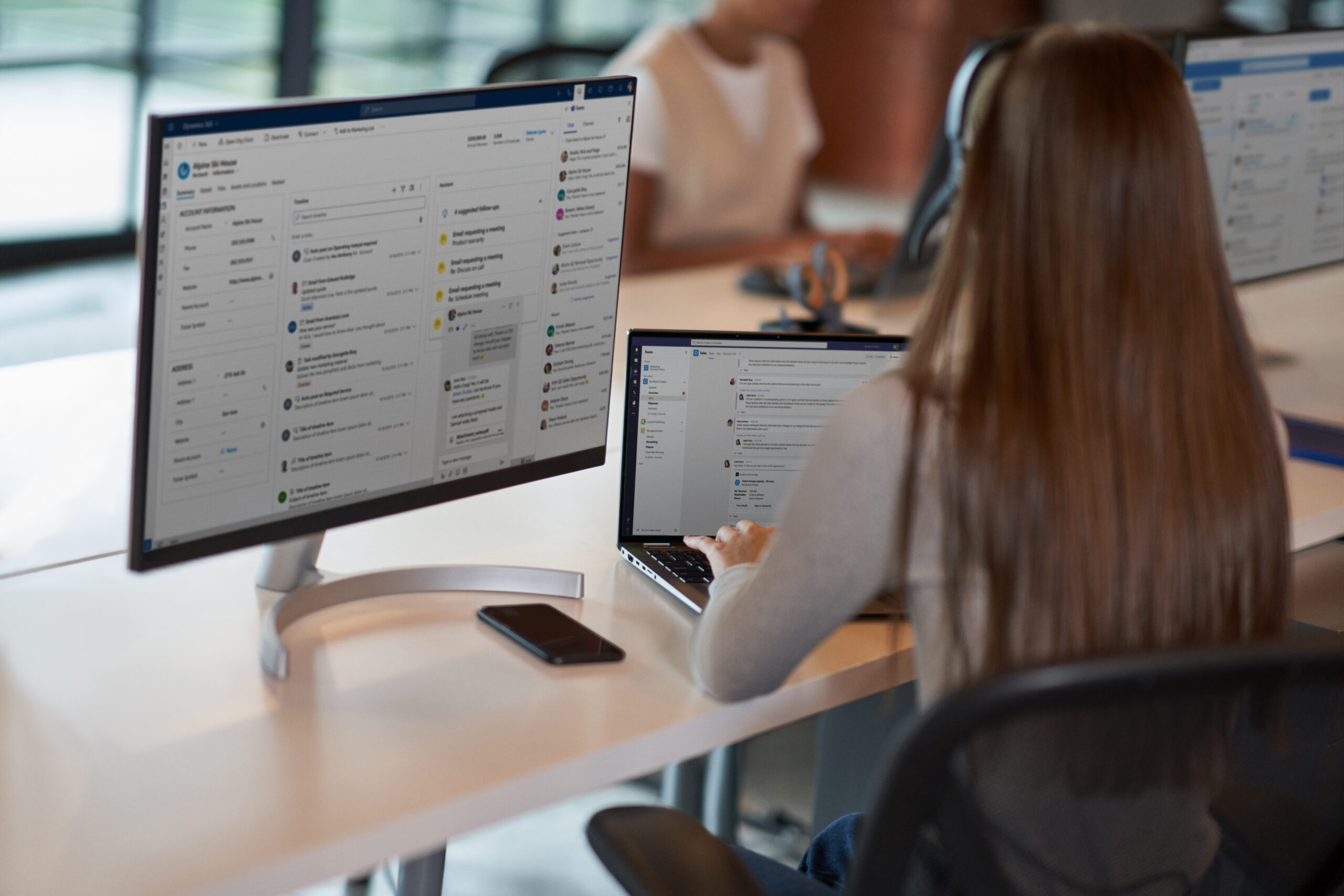 person sitting in front of two monitors