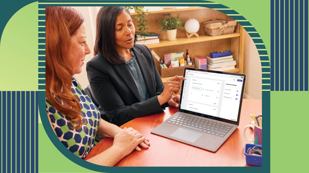 Two educators sitting together and reviewing a student&rsquo;s Math Progress assignment