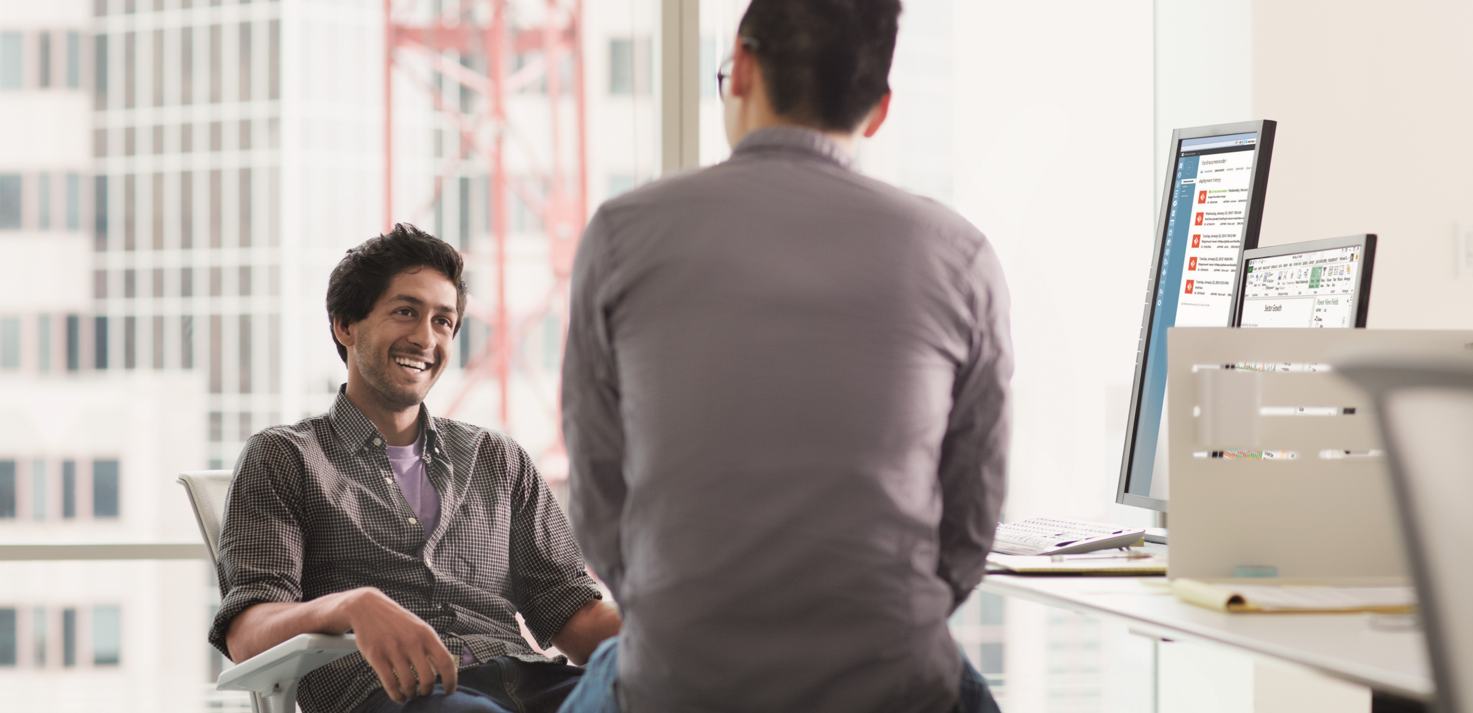 Two men sitting in an office working
