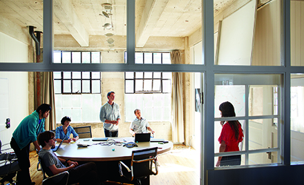 Image of four coworkers collaborating in an office