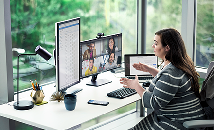 Image showing a woman working at her desk, holding an online meeting