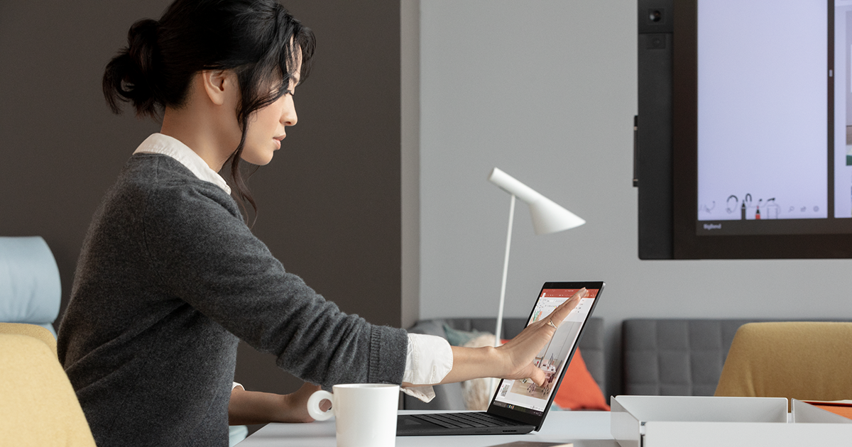 An image of a female tech worker using a laptop