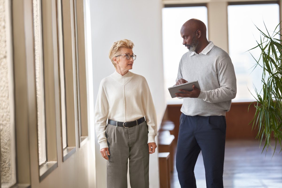 Employees talking in a hallway