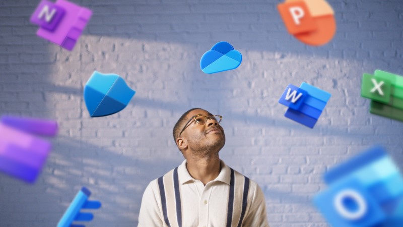 Young employee looking around with floating Microsoft 365 product icons floating around