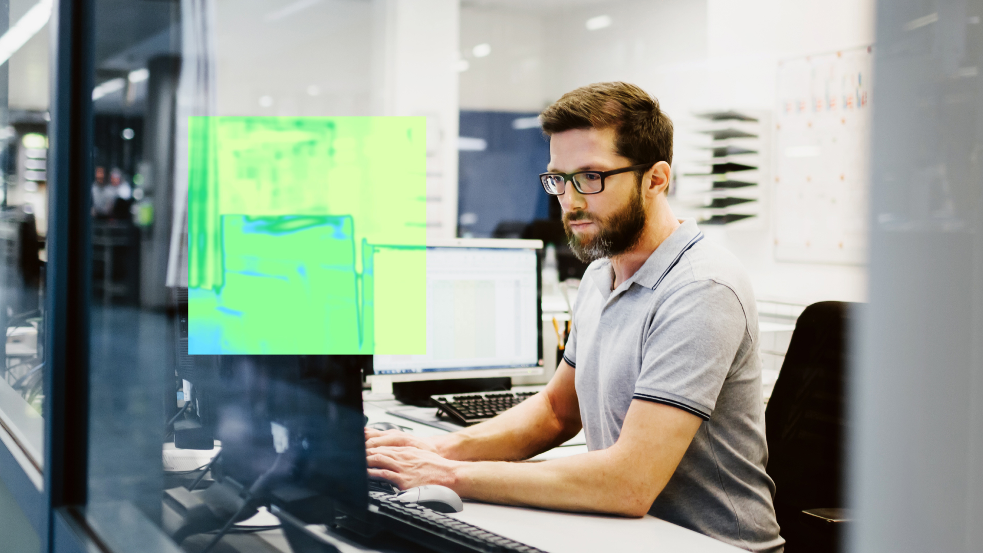A security practitioner works at a computer