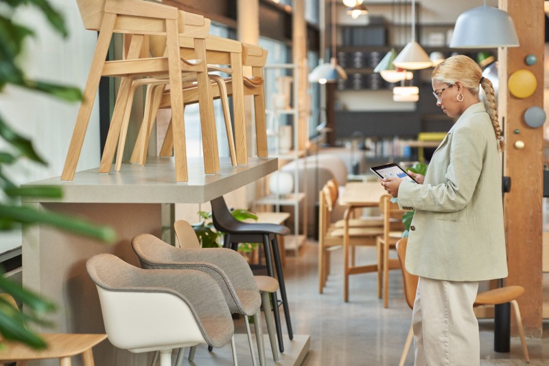 Retail store manager using a tablet to analyze floor and endcap data