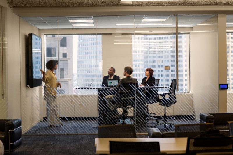 Sales team at large Financial Company. Group sales meeting and CEO presentation. Female sales manager presents product to CEO. ITPro, CFO and CEO meet with sales lead