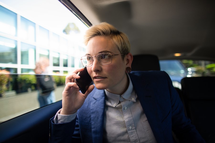 Businessperson talks on mobile phone with representative