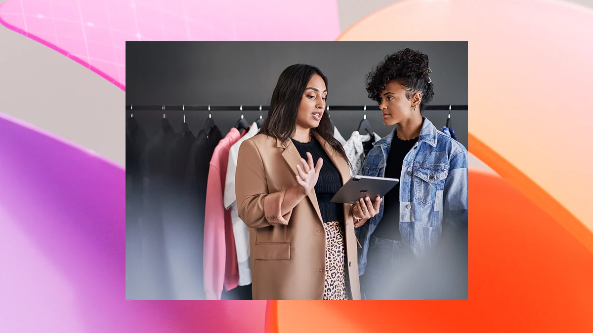 Empowered retail business manager reviewing real time data with employee
